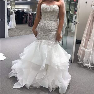 Brand New with tags tried on once. Designer wedding dress from David’s bridal.